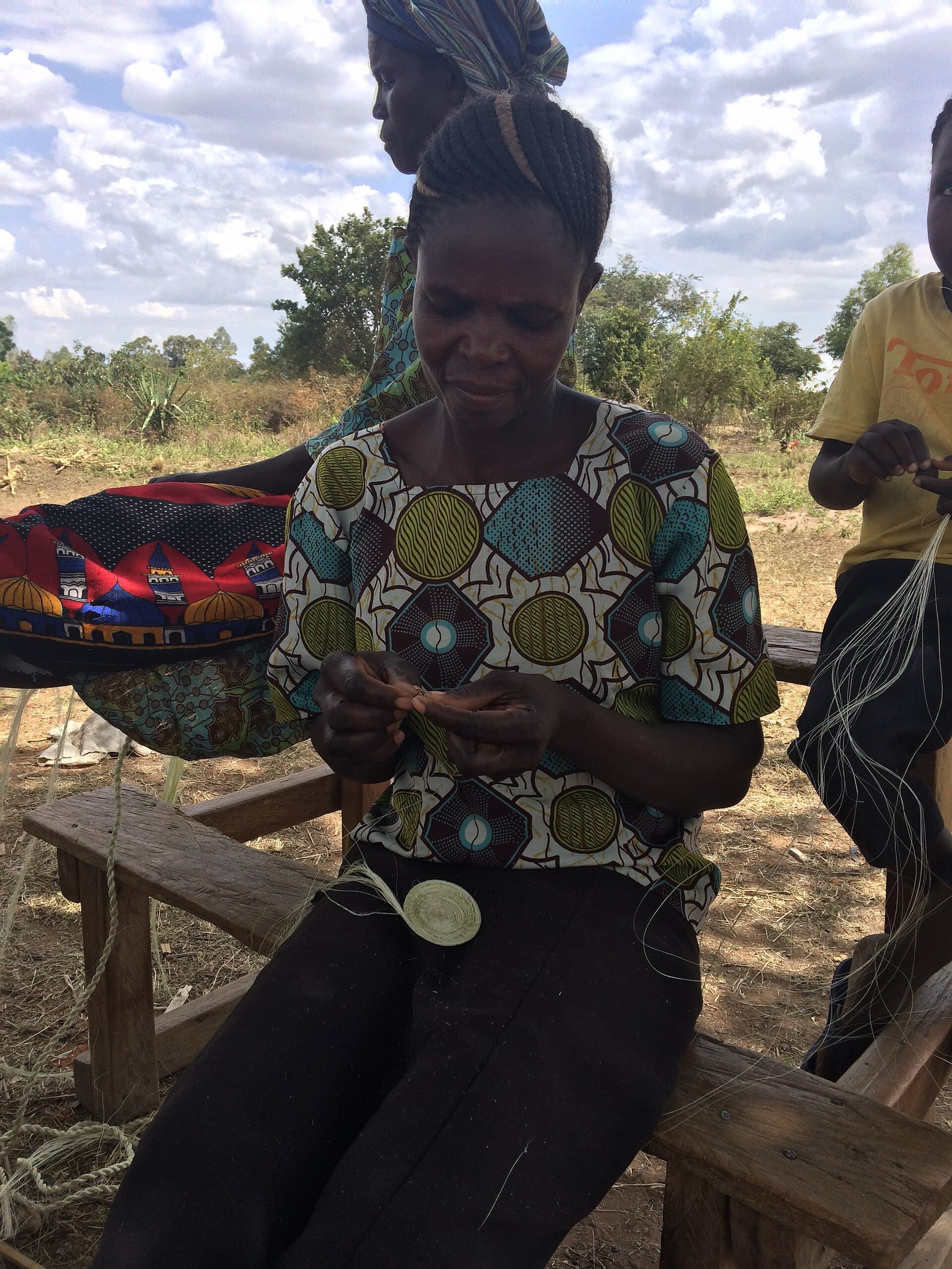 A relationship officer coaching a client in her community